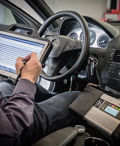 Expert mechanic doing car diagnostics